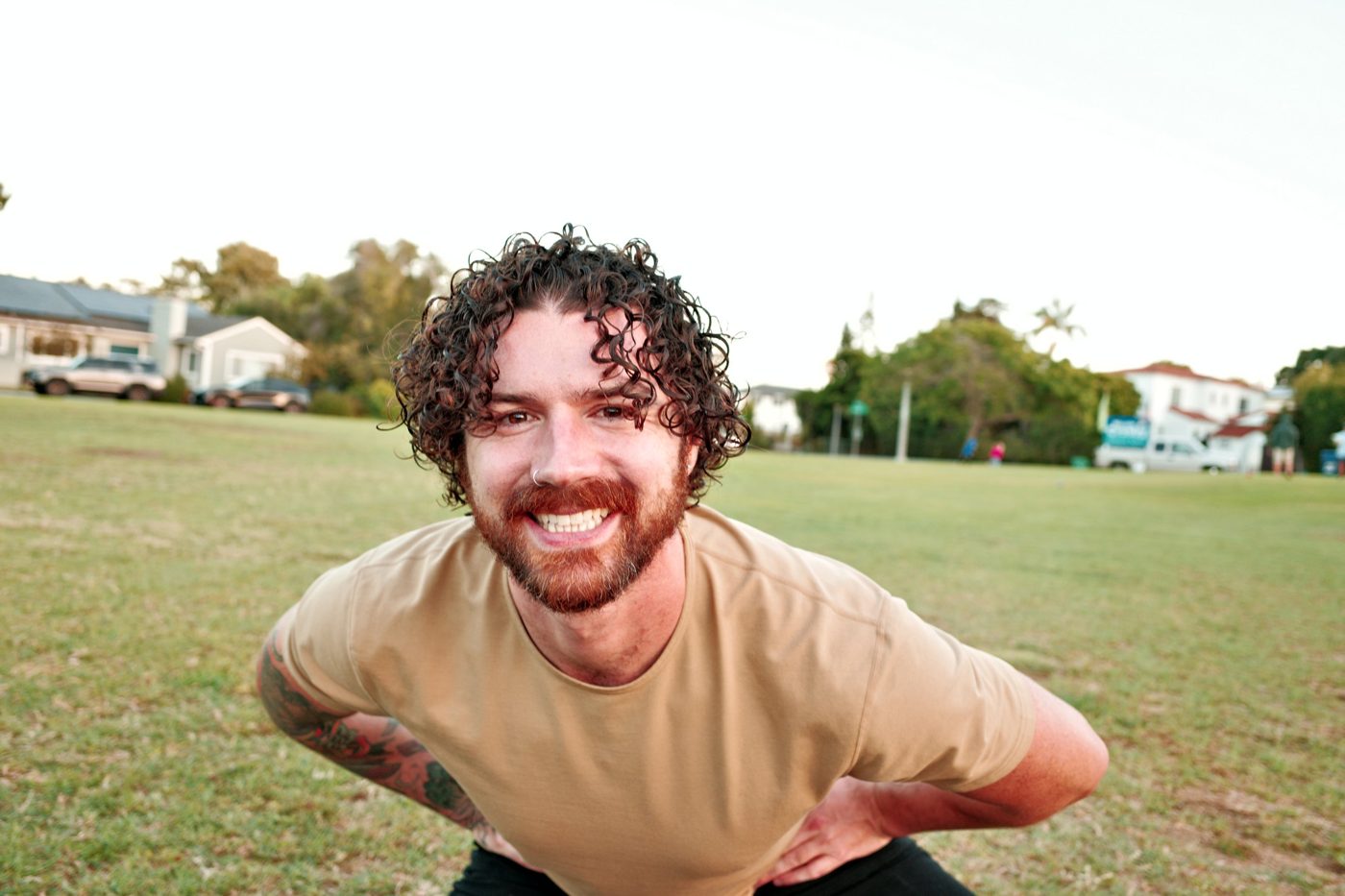 Zach, founder of iamofbody, smiling in a park in San Diego